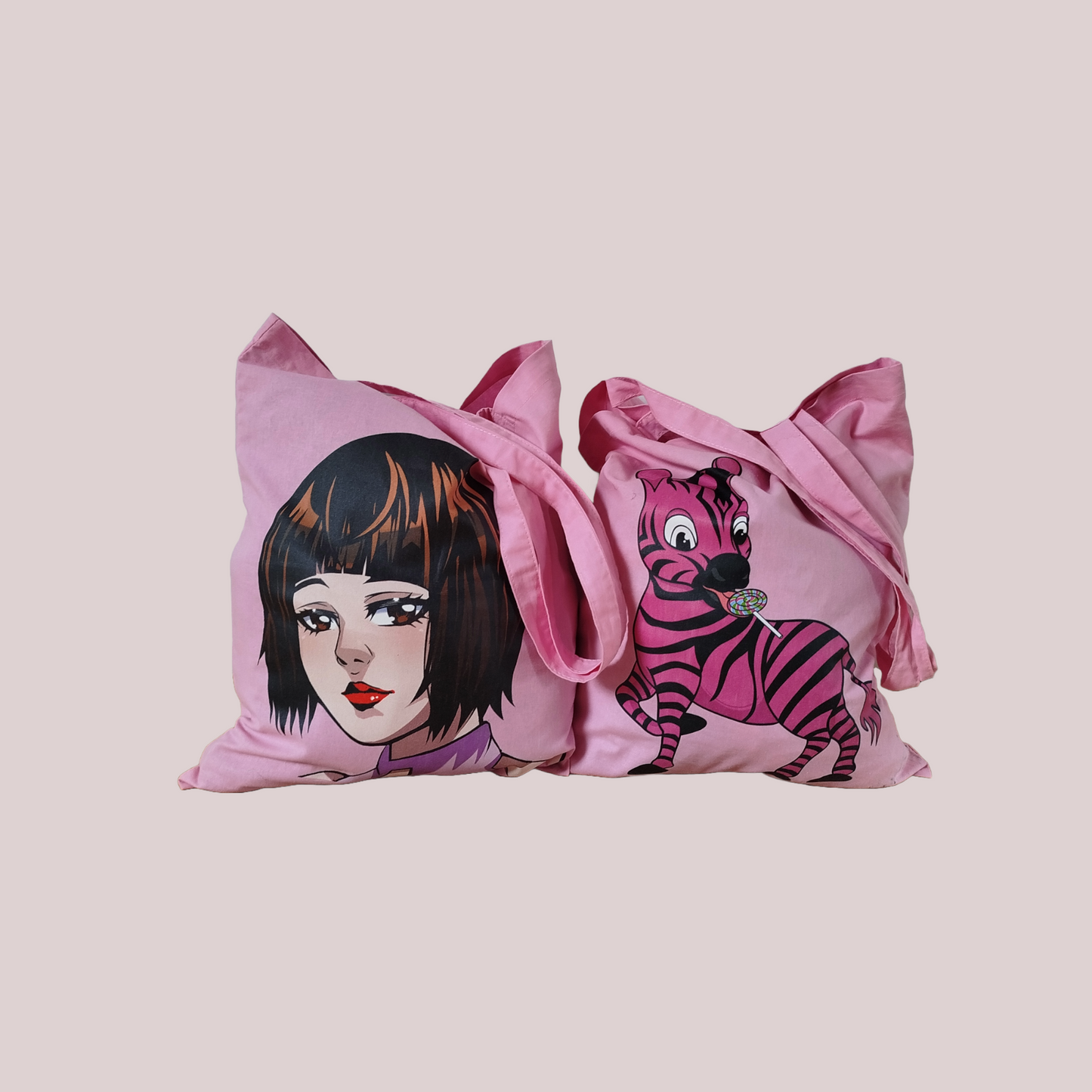 Two pink cotton tote bags with anime and zebra cartoon character designs