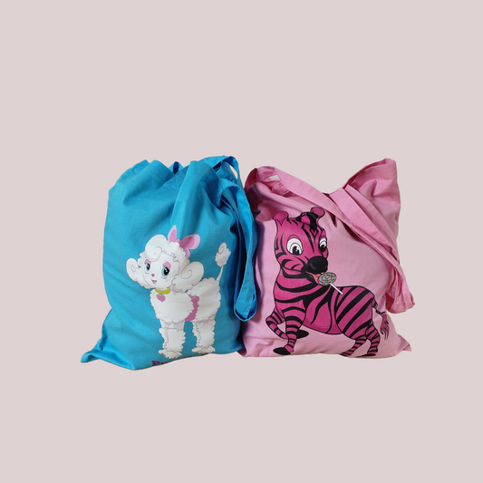 Two cotton tote bags, one blue with a white poodle dog design and one pink with a cartoon zebra design